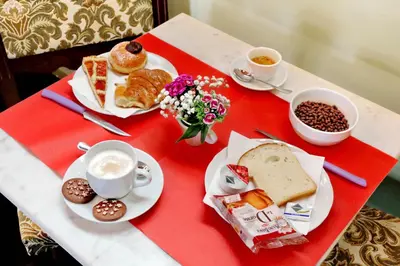 a table topped with plates of food and cups of coffee at Antico Platano in Rome
