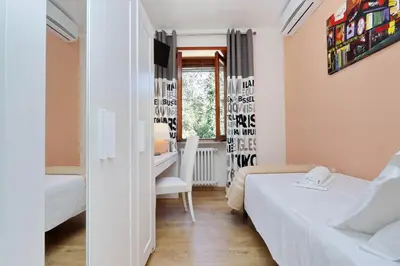 a small room with two beds and a desk at Antico Platano in Rome