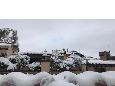 a pile of snow on the roofs of buildings at Nido tra le cupole, terrazza panoramica, Wi-Fi , AC in Rome