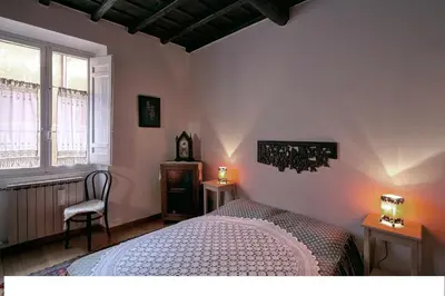 a bedroom with a bed and two tables and a window at Nido tra le cupole, terrazza panoramica, Wi-Fi , AC in Rome