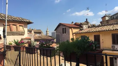 a balcony with potted plants on a fence at Nido tra le cupole, terrazza panoramica, Wi-Fi , AC in Rome