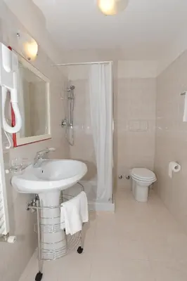 a bathroom with a sink and a shower and a toilet at Startermini in Rome
