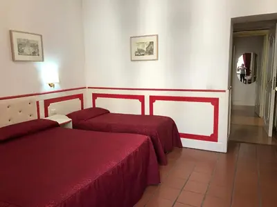 a hotel room with two beds and a hallway at Startermini in Rome