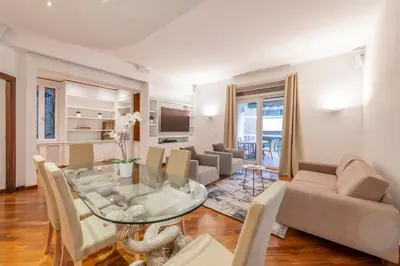 a living room with a glass table and chairs at ROMA 1 - Elegante Appartamento con Terrazzo in Rome
