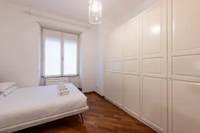 a white bedroom with a bed and a window at ROMA 1 - Elegante Appartamento con Terrazzo in Rome