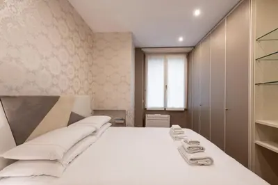 a bedroom with a white bed and a window at ROMA 1 - Elegante Appartamento con Terrazzo in Rome