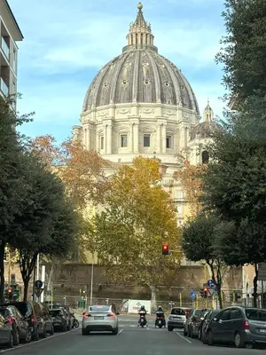 a large white building with a domed building at Maison Fortuna in Rome