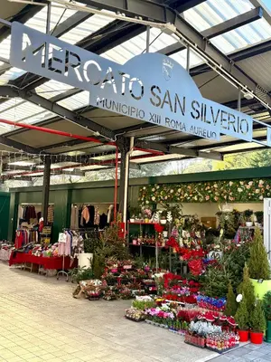 a market with a display of flowers and plants at Maison Fortuna in Rome