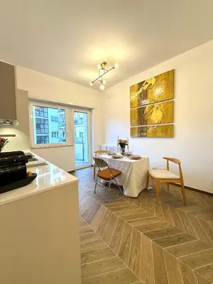 a kitchen and dining room with a table and chairs at Maison Fortuna in Rome