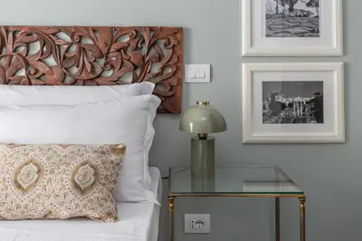 a bedroom with a bed with a glass table next to it at Chic Spanish Steps Retreat in Rome