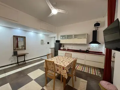 a kitchen with a table and chairs in a room at Warm Hideaway in Vibrant Tuscolano in Rome