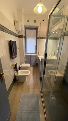 a bathroom with two toilets and a sink and a shower at Lepanto Lovely Apartment in Rome