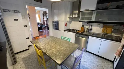 a kitchen with a table and chairs in it at Lepanto Lovely Apartment in Rome