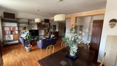 a living room with a dining room table and a living room with at Lepanto Lovely Apartment in Rome