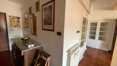 a room with a hallway with a table and a door at Lepanto Lovely Apartment in Rome