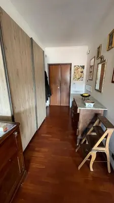 a living room with a table and a wooden floor at Lepanto Lovely Apartment in Rome