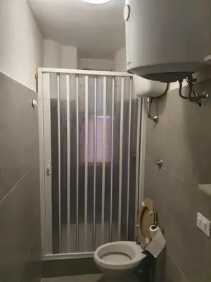 a small bathroom with a toilet with a gate at Tom 38 in Rome