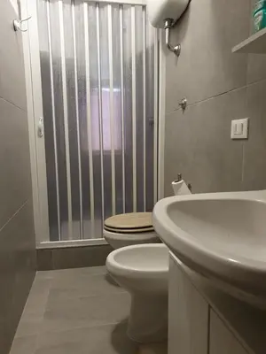 a bathroom with a toilet and a sink at Tom 38 in Rome