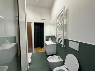 a bathroom with a white toilet and a sink at Little Diamond in Gianicolense in Rome