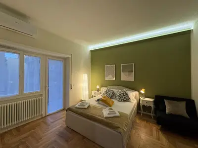 a bedroom with a bed and a large window at Little Diamond in Gianicolense in Rome