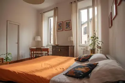 a bedroom with a large bed with two pillows on it at Fissa Dimora in Rome