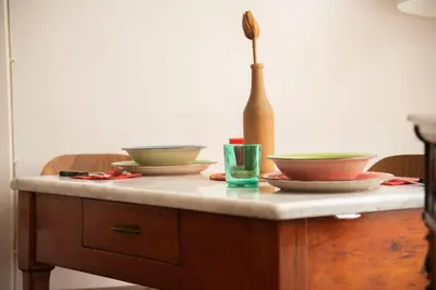 a table with two bowls and a bottle on it at Fissa Dimora in Rome