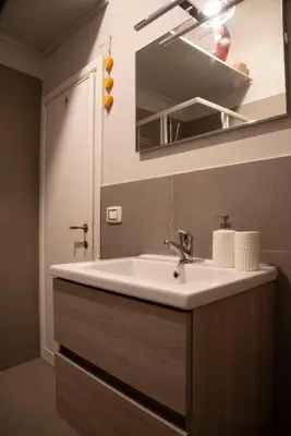 a bathroom with a sink and a mirror at Fissa Dimora in Rome