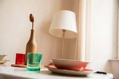 a table with a vase and a bowl and a lamp at Fissa Dimora in Rome