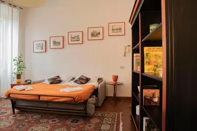 a bedroom with a bed and a book shelf at Fissa Dimora in Rome