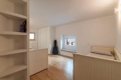 a bedroom with a bed and a guitar in a room at Luxury 3 beds 3 baths, few steps from city center in Rome