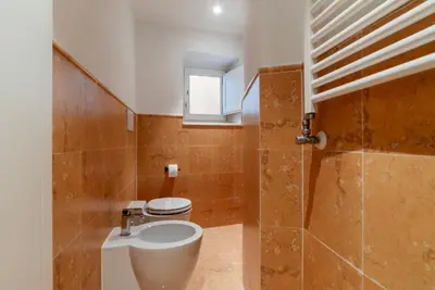 a bathroom with a toilet and a sink at Luxury 3 beds 3 baths, few steps from city center in Rome