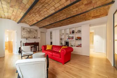 a living room with a red couch and a table at Luxury 3 beds 3 baths, few steps from city center in Rome