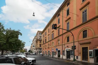 a traffic light on a street next to a building at Luxury 3 beds 3 baths, few steps from city center in Rome