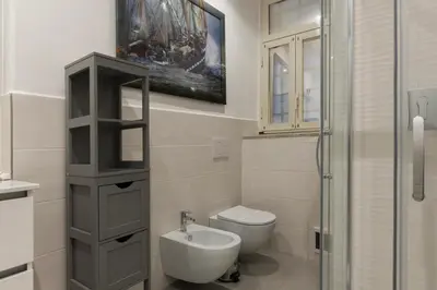 a bathroom with a toilet and a sink and a shower at The Mirror Suite next to Spanish Steps in Rome