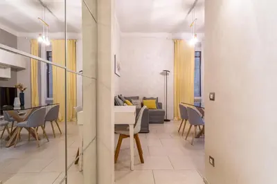a living room and dining room with a table and chairs at Iflat Cozy Flat at two steps from Vatican in Rome