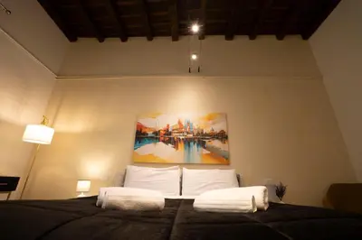 a dining room with a table and chairs and a tv at Designer Apartment 5' Pantheon Wi-Fi & AC in Rome