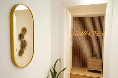 a white bedroom with a bed with white shelves at Designer Apartment 5' Pantheon Wi-Fi & AC in Rome
