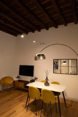 a living room with a white couch and yellow pillows at Designer Apartment 5' Pantheon Wi-Fi & AC in Rome