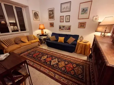 a living room with a couch and a rug at Casa di Michele in Rome