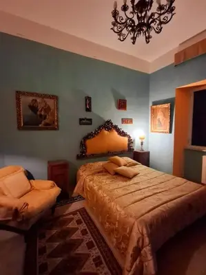 a bedroom with a bed and a chandelier at Casa di Michele in Rome