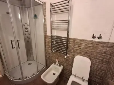 a bathroom with a shower and a toilet and a sink at Casa di Michele in Rome