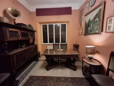 a living room with a table and a window at Casa di Michele in Rome