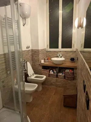 a bathroom with a toilet and a sink at Casa di Michele in Rome