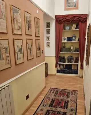 a hallway with a staircase with pictures on the wall at Casa di Michele in Rome