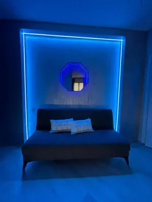 a blue room with a couch and a mirror at Breath of Rome 5 min a piedi metro B San paolo poche fermate dal centro di Roma in Rome