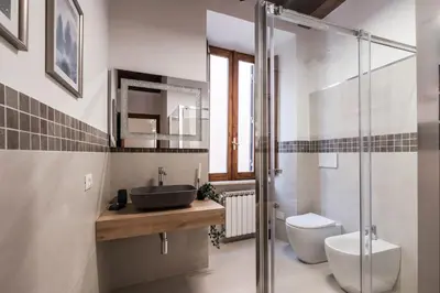 a bathroom with a sink and a toilet at The Best Rent - Peaceful oasis with garden near the Colosseum in Rome
