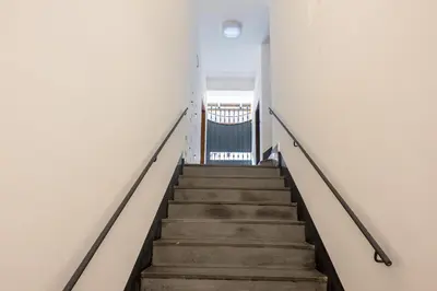 a staircase in an office building with a stair case at The Best Rent - Peaceful oasis with garden near the Colosseum in Rome