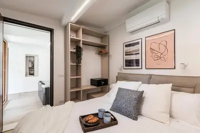 a bedroom with a bed with a tray of donuts on it at The Best Rent - Peaceful oasis with garden near the Colosseum in Rome