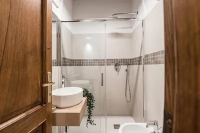 a bathroom with a shower and a toilet and a sink at The Best Rent - Peaceful oasis with garden near the Colosseum in Rome