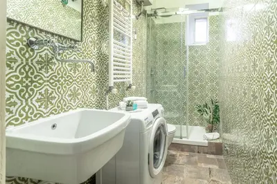 a bathroom with a sink and a washing machine at Iflat Comfortable & Spacious Dolce Vita Retreat in Rome